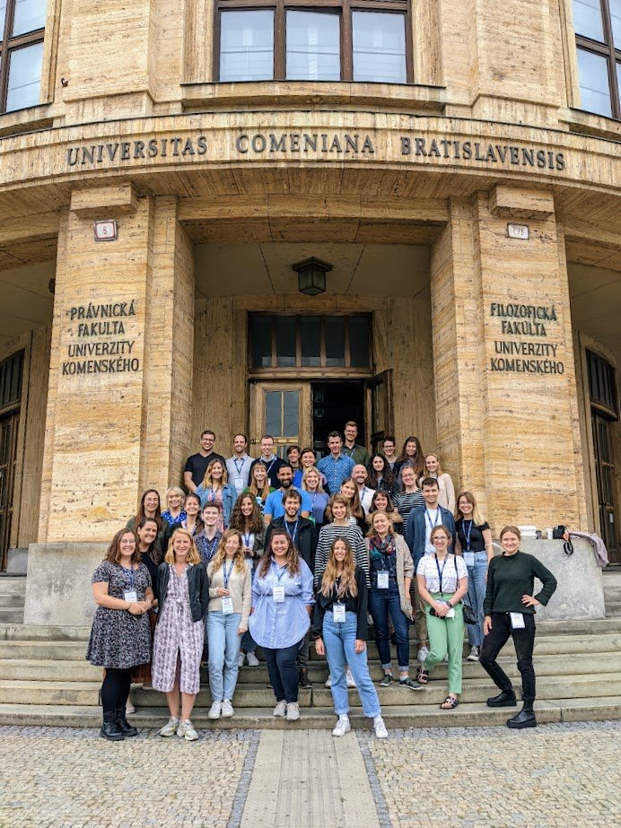 Group photo of workshop participants on the steps of Comenius University in Bratislava