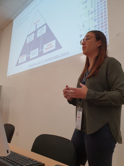 Dr Olga Perski presenting to a workshop audience in front of a projected slide